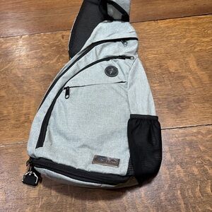 Versatile Gray Sling Backpack with Multiple Compartments